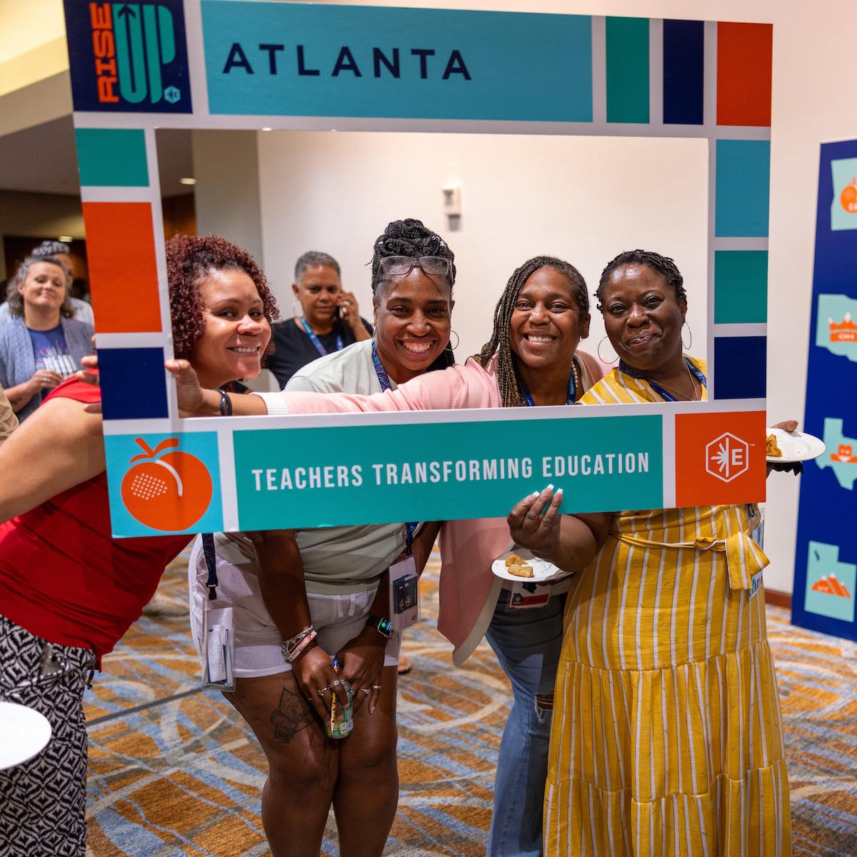 Group of teachers posing in a large frame at the teachers transforming education conference