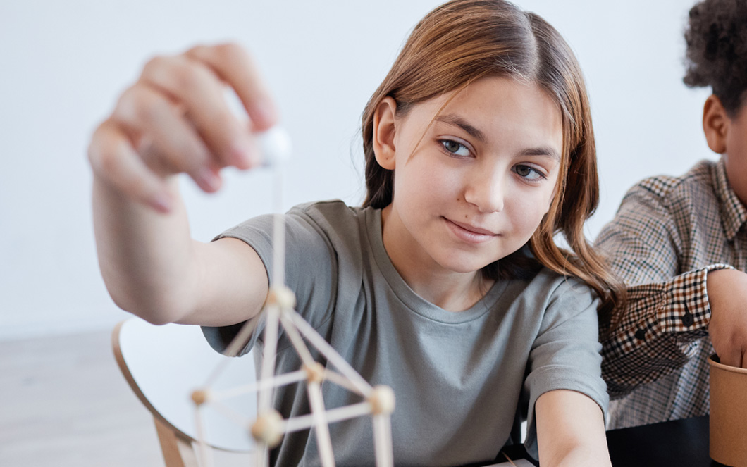 Teen student building tower
