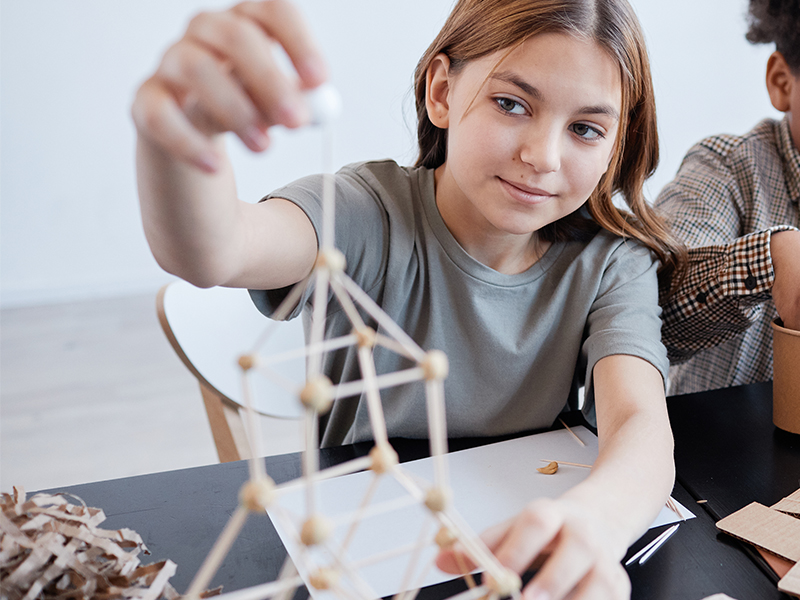 Teen student building a tower